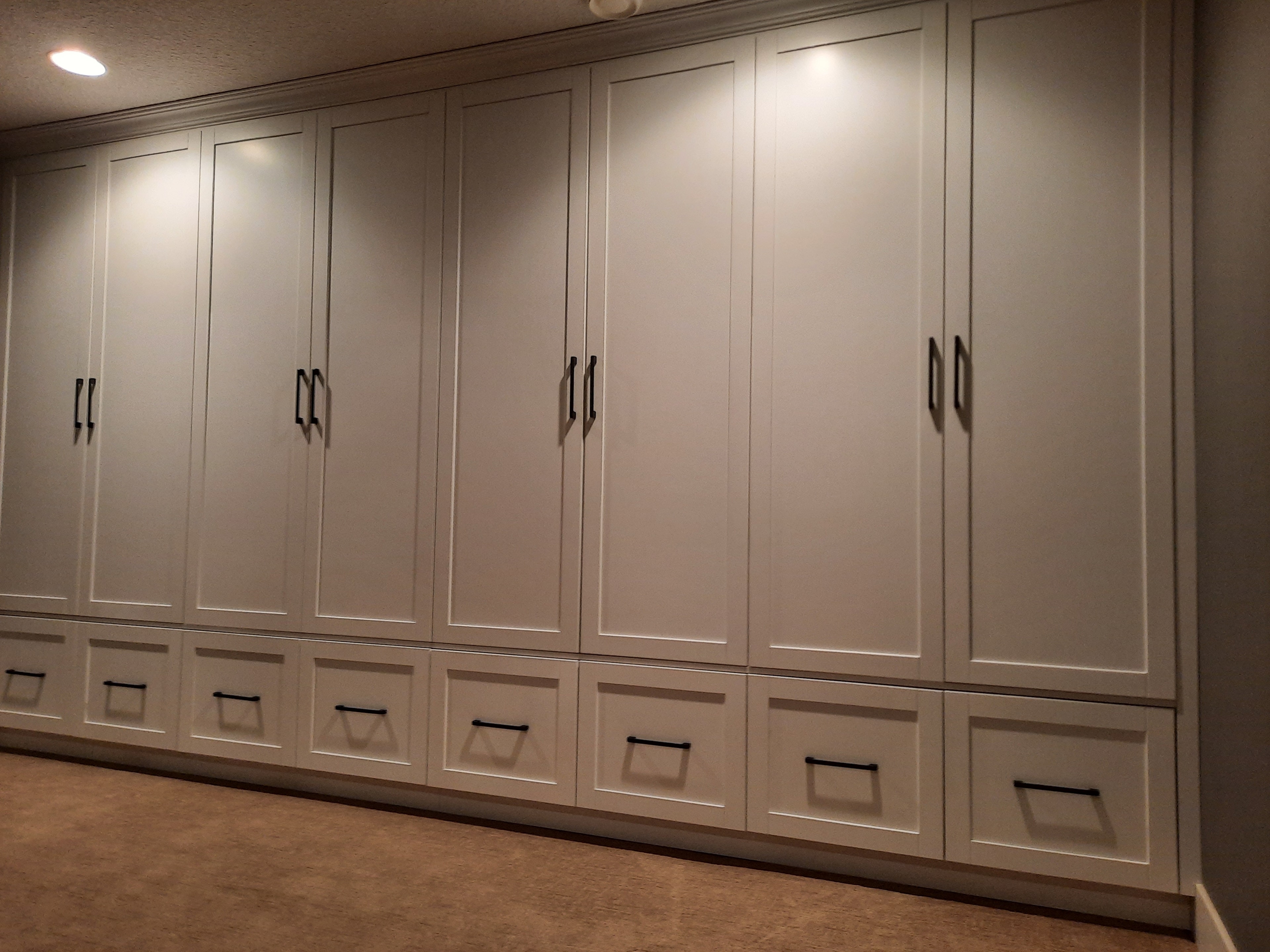 Custom walk-in closet with white shelving and hanging rods