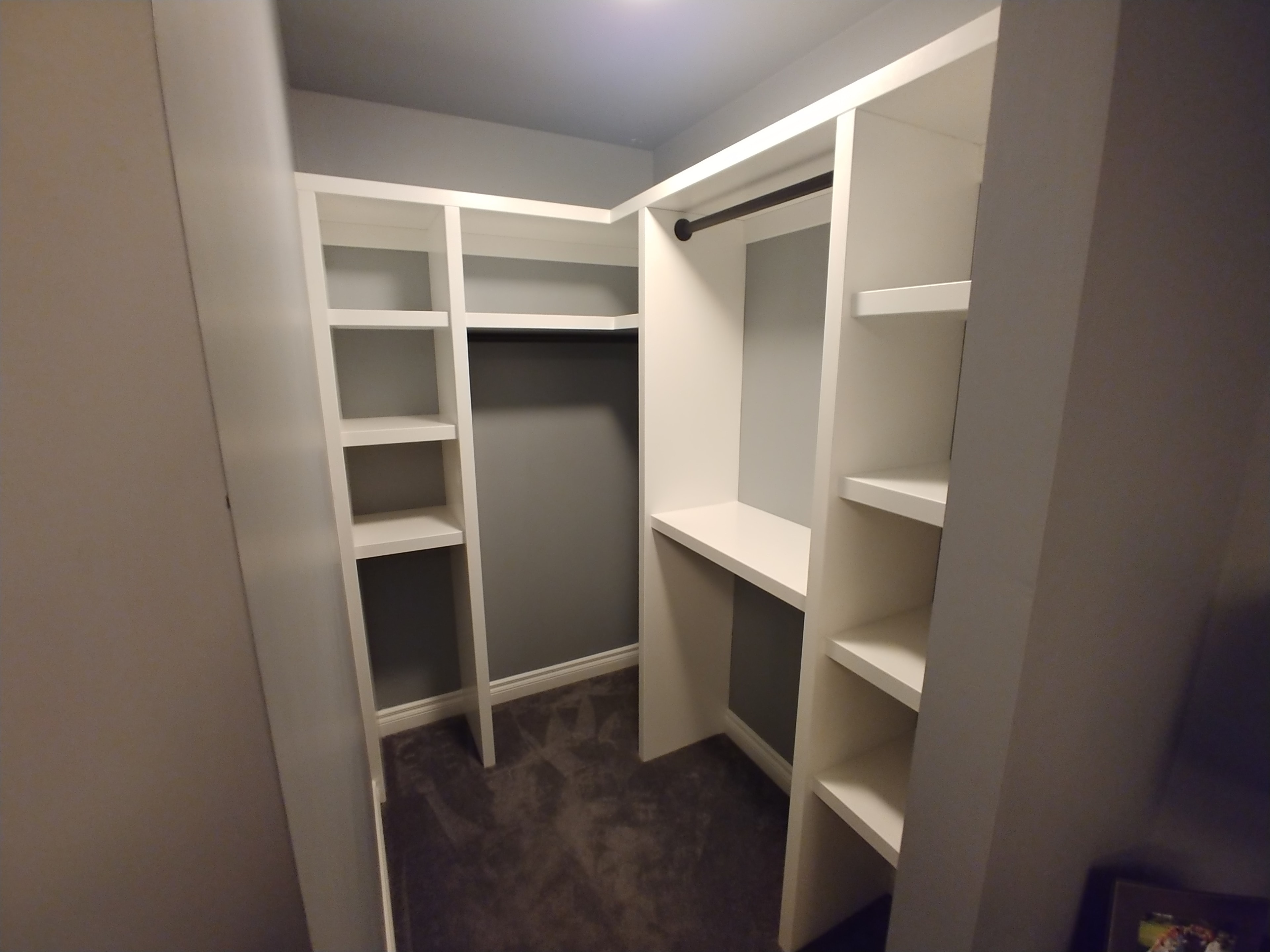 Custom mudroom bench with board and batten, black hooks and dark wood bench top