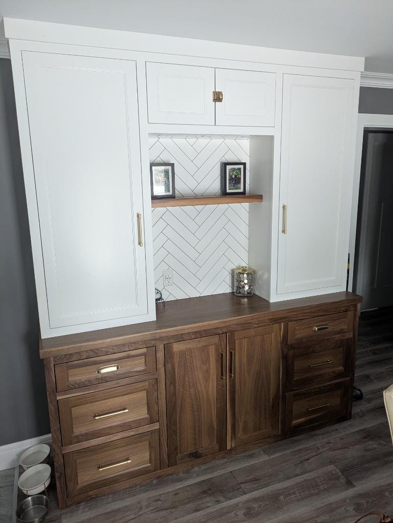 Custom built-in cabinetry with white cabinets and cherry wood countertops